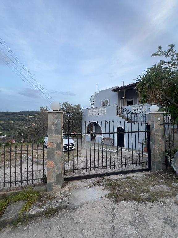 a gate in front of a white house at V&M Residence - Ground Level in Mesagrós