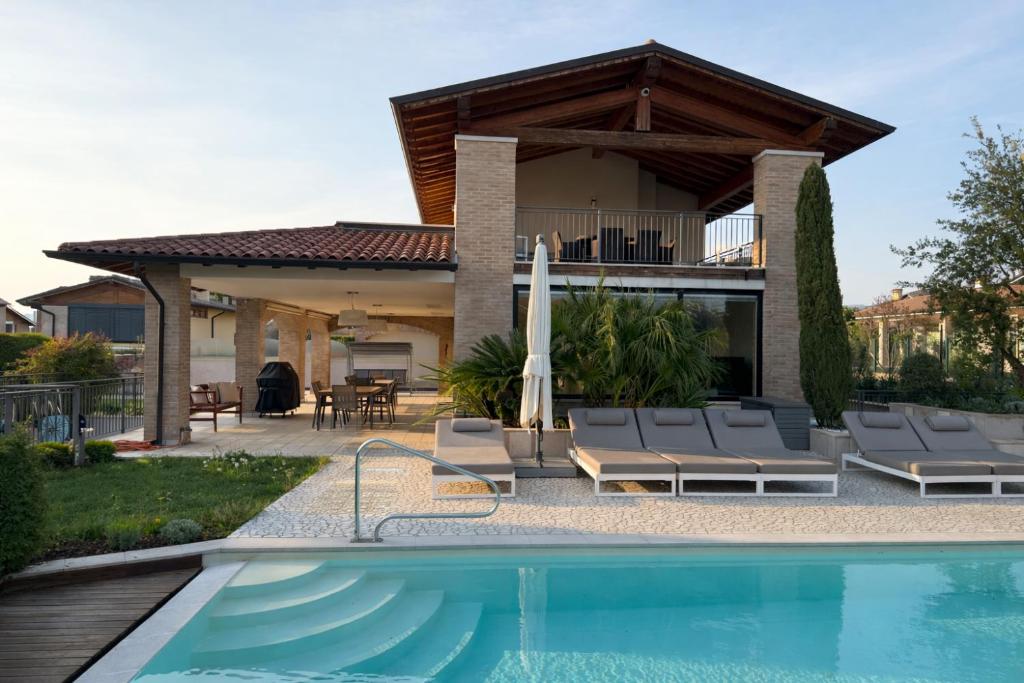 a villa with a swimming pool and a house at Pool Villa Lazise in Lazise