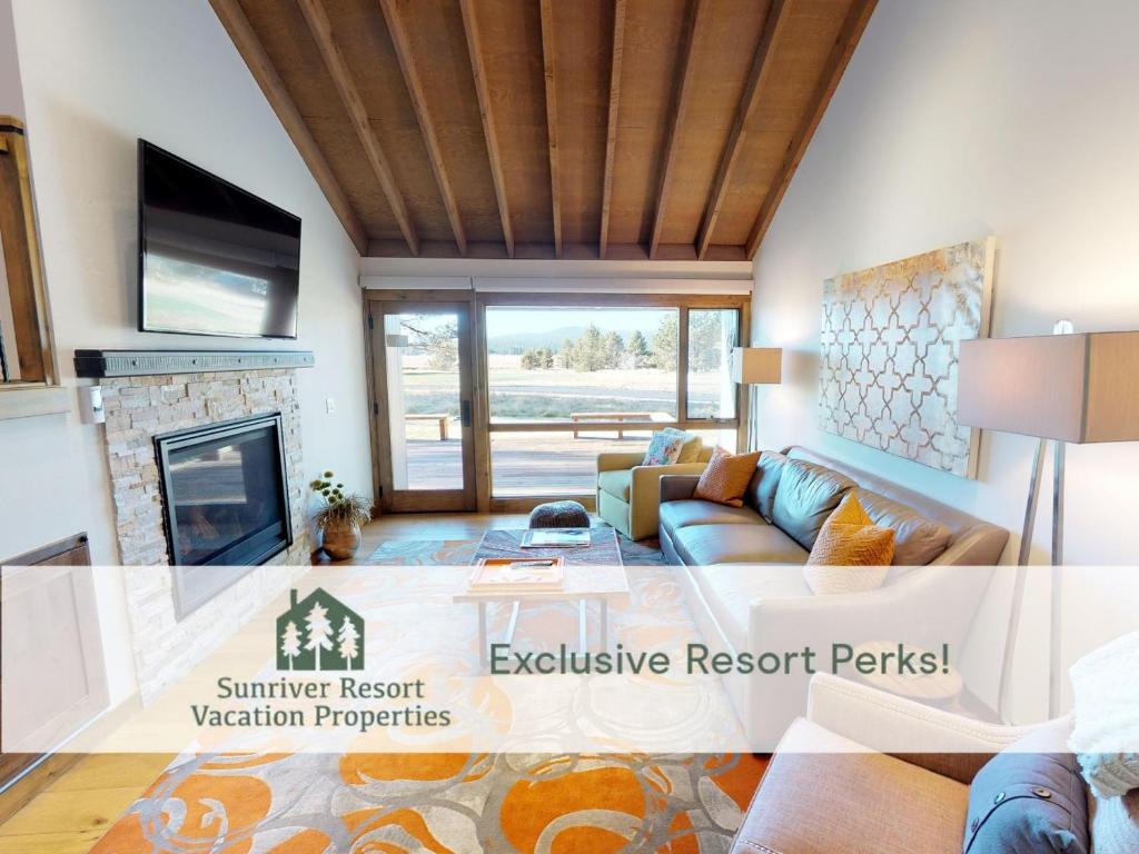 a living room with a couch and a fireplace at 63 Meadow House in Sunriver