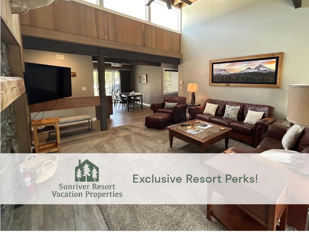 a living room with a couch and a tv at 73 Meadow House in Sunriver