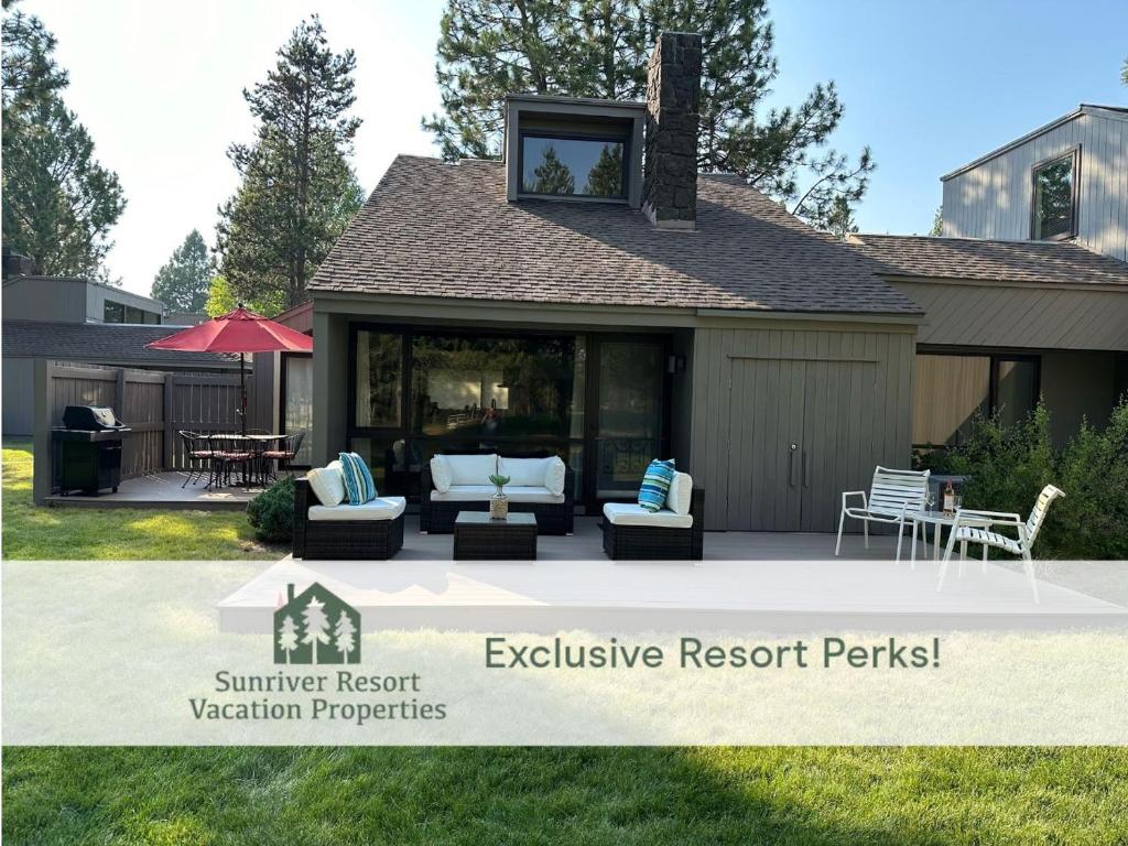 a house with a patio with couches and an outside resort perk at 79 Meadow House in Sunriver