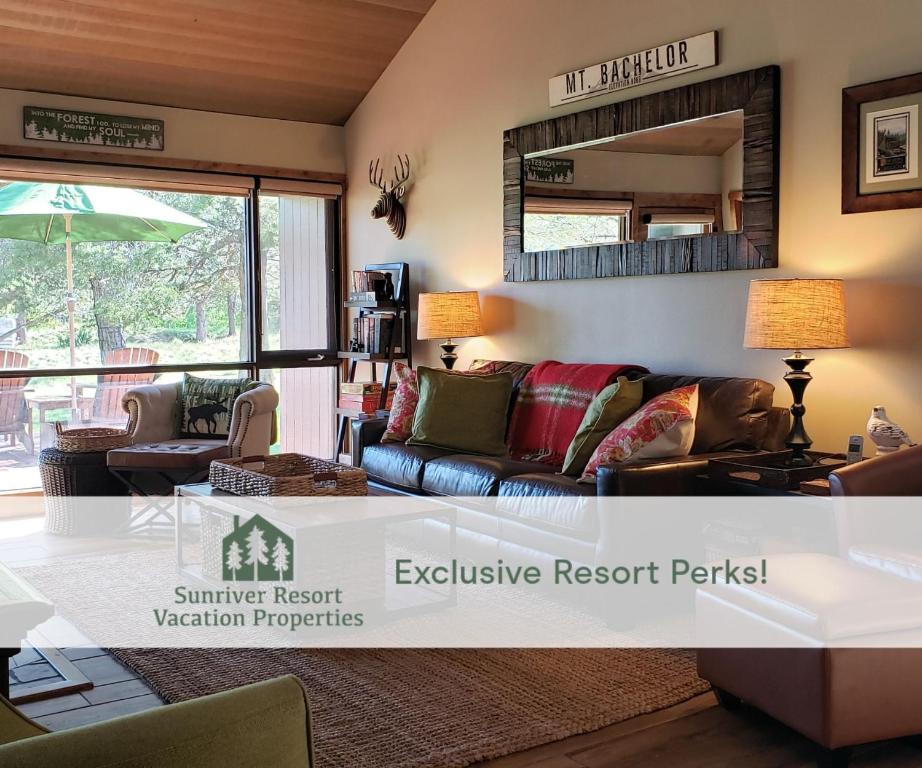 a living room with a couch and a mirror at 81 Meadow Lane in Sunriver