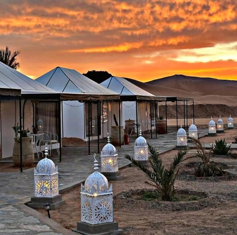 a group of domes with lights in the desert at Camp Merzouga Sand Explorer in Merzouga