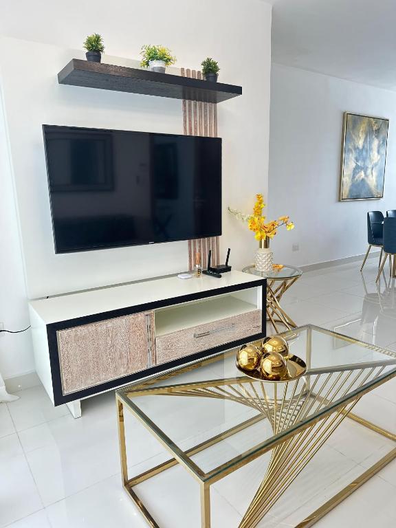 a living room with a large television on a wall at residencial enmanuel 1 in Hoya del Caimito