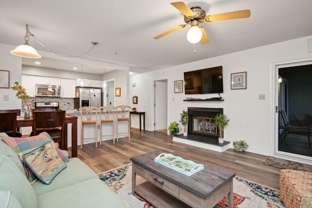 a living room with a couch and a table at 36 Bunker Court by Oak Island Accommodations in Caswell Beach