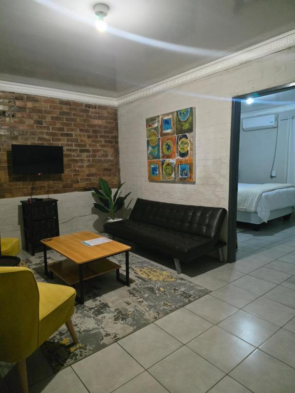 a living room with a couch and a bed at Vista Ree Guesthouse Pty Ltd in Taung