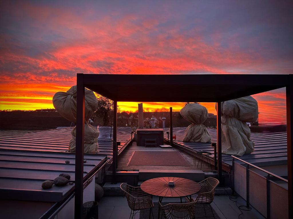 a view of a sunset from the deck of a boat at Private Spa Loft in Roding