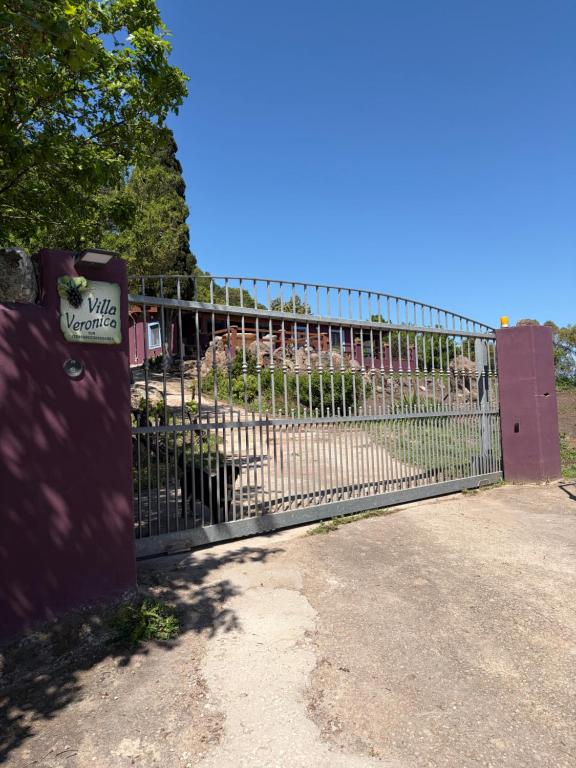 a large metal gate with a sign on it at Villa Veronica in Sedini