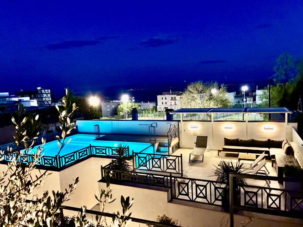 a swimming pool on the roof of a building at night at Luxury house Prestige Split in Split
