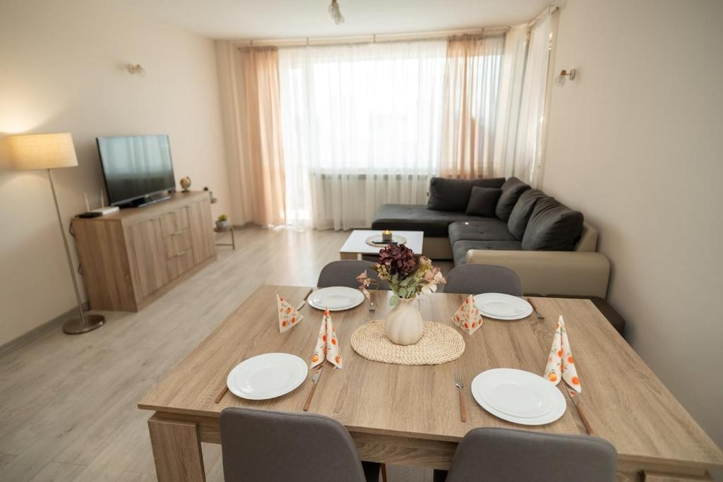 a living room with a table with chairs and a couch at Active Homes in Veliko Tŭrnovo