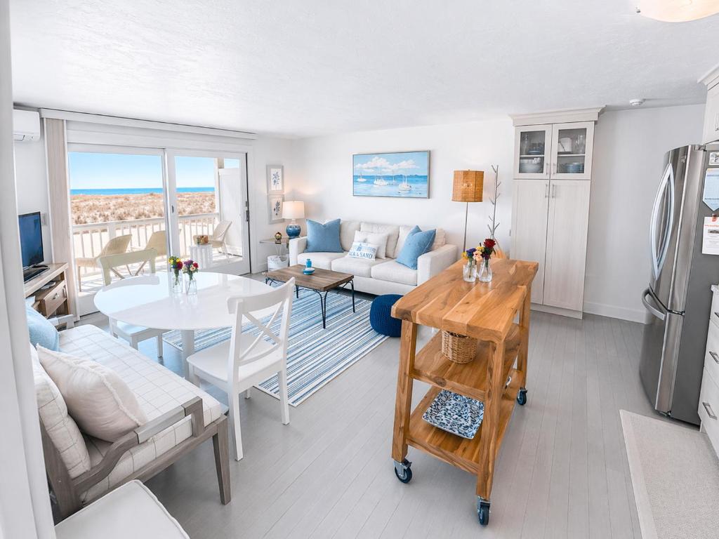 a living room with a couch and a table at Stunning Bay Views | Beach Access - Deck - Parking in Provincetown