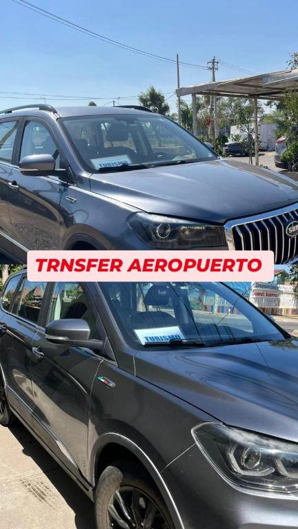 two cars parked next to each other in a parking lot at Hostal Brisa Serena in Santiago