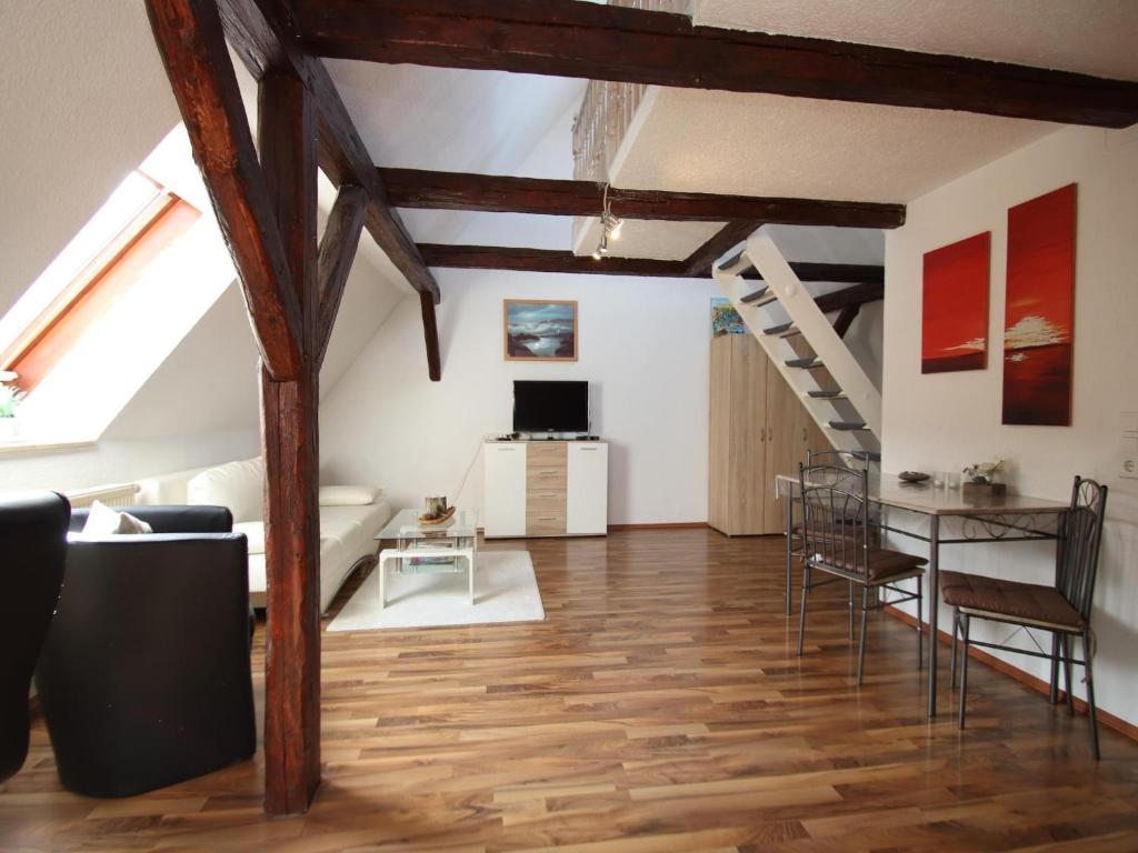 a living room with wooden floors and wooden beams at behagliche Ferienwohnung in Elbingerode in Elbingerode