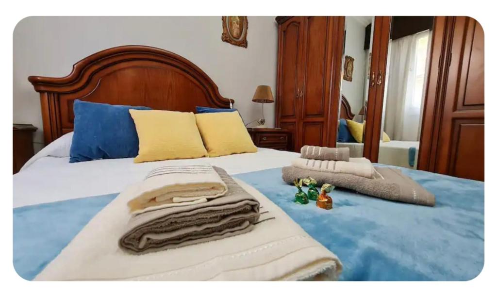 a bedroom with a bed with towels on it at Casa Lali in Redondela