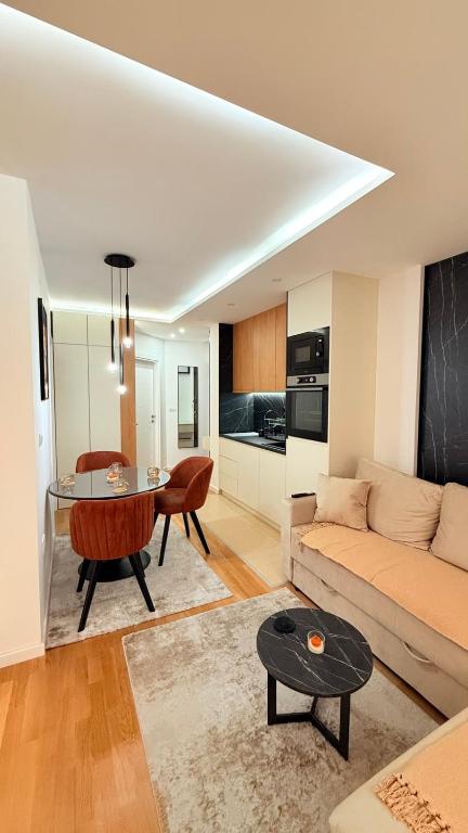 a living room with a couch and a table at Altura Garden 1 in Vrnjačka Banja