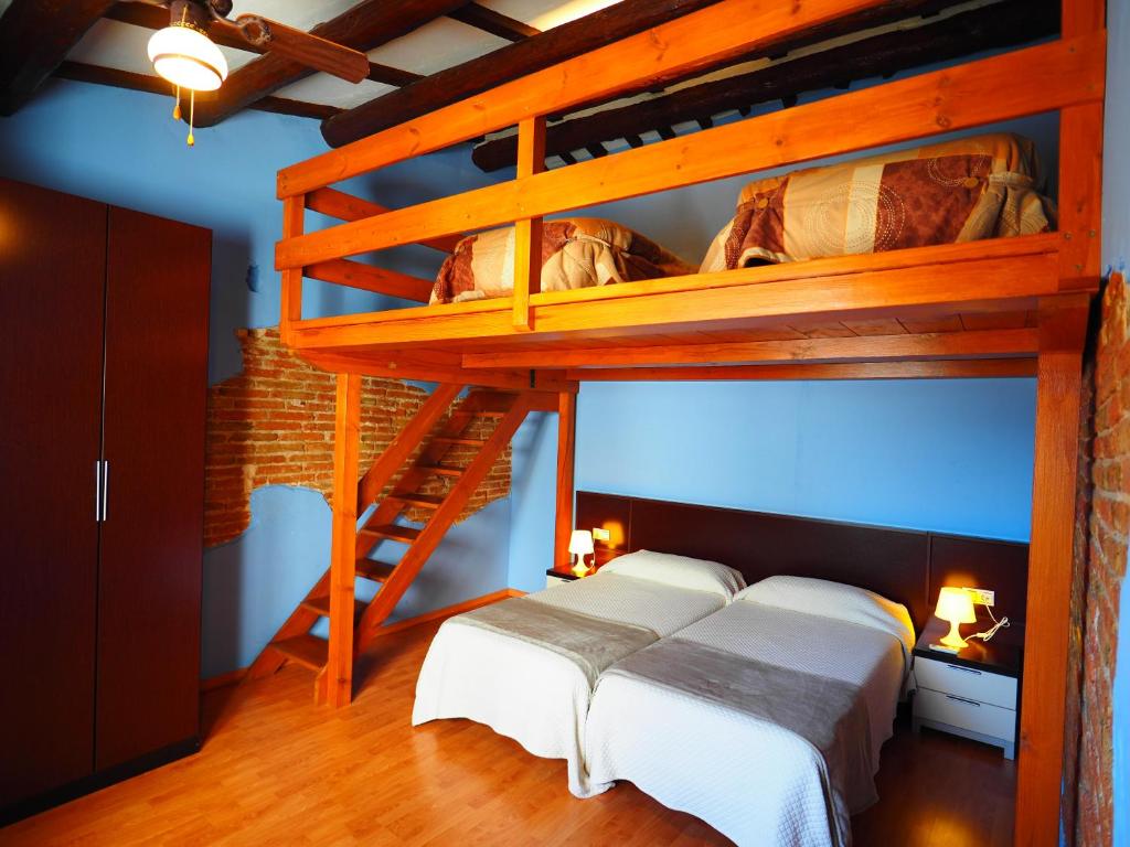 a bedroom with a loft bed with two beds at Apartaments El Jaç in Montblanc