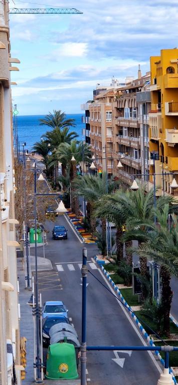 a view of a city street with palm trees and buildings at Apartament La Torre in Torrevieja