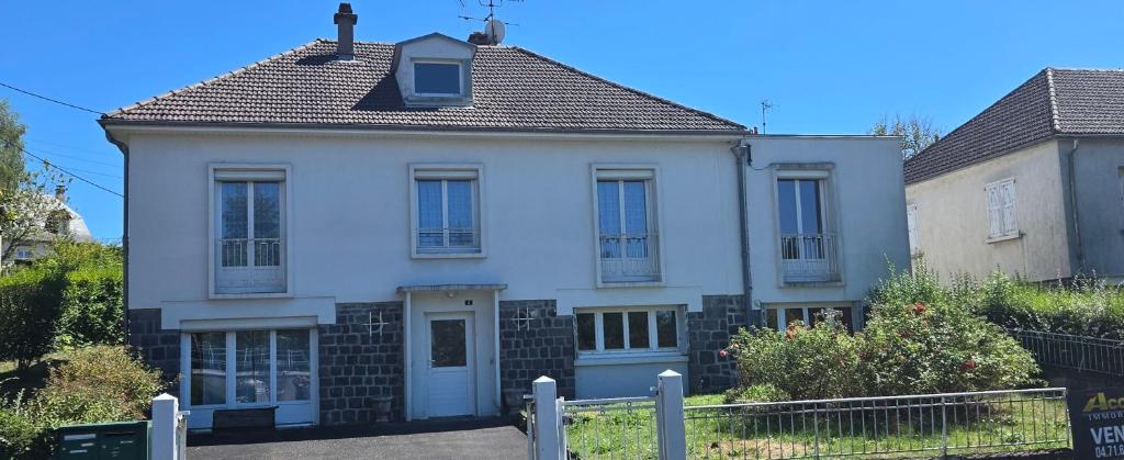 a white house with a fence in front of it at Résidence Mauriac in Mauriac