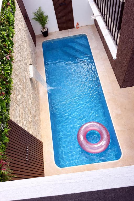 a swimming pool with a red ring in the water at Modern Villa near Lisbon & Beaches with Heated Pool in Fernao Ferro