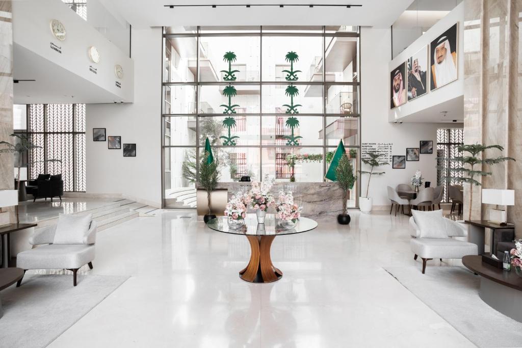 a lobby with a table and chairs in a building at Liora Al Yasmin District in Riyadh