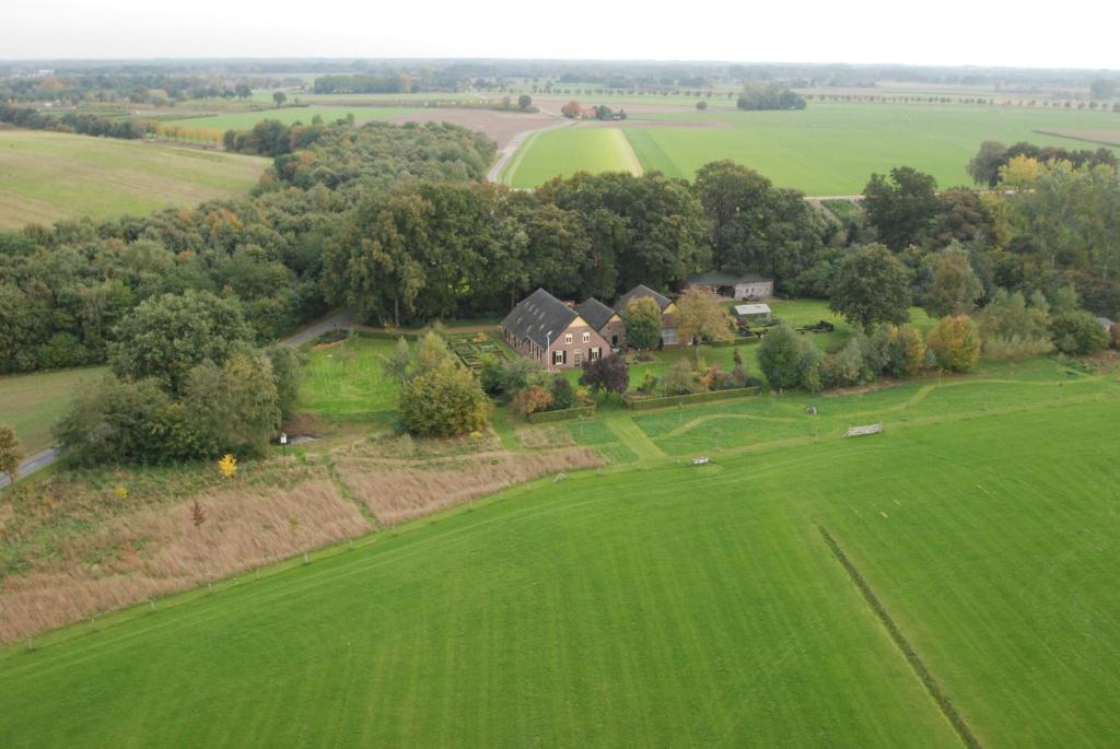 an aerial view of a house in a green field at Gastenverblijf Eenink in Zelhem