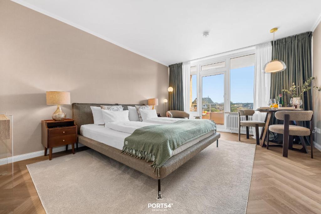 a bedroom with a bed and a dining room with a table at Ferienwohnung Margaritha List auf Sylt in List
