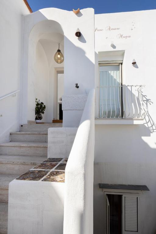 a staircase in a house with white walls and white stairs at Pane Amore e Magia in Anacapri