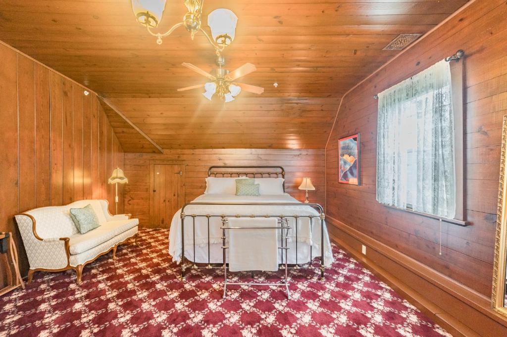 a bedroom with a bed and a chair in a room at Desperado - CA King Size Bed - Sleeps 2-4 in Lynchburg