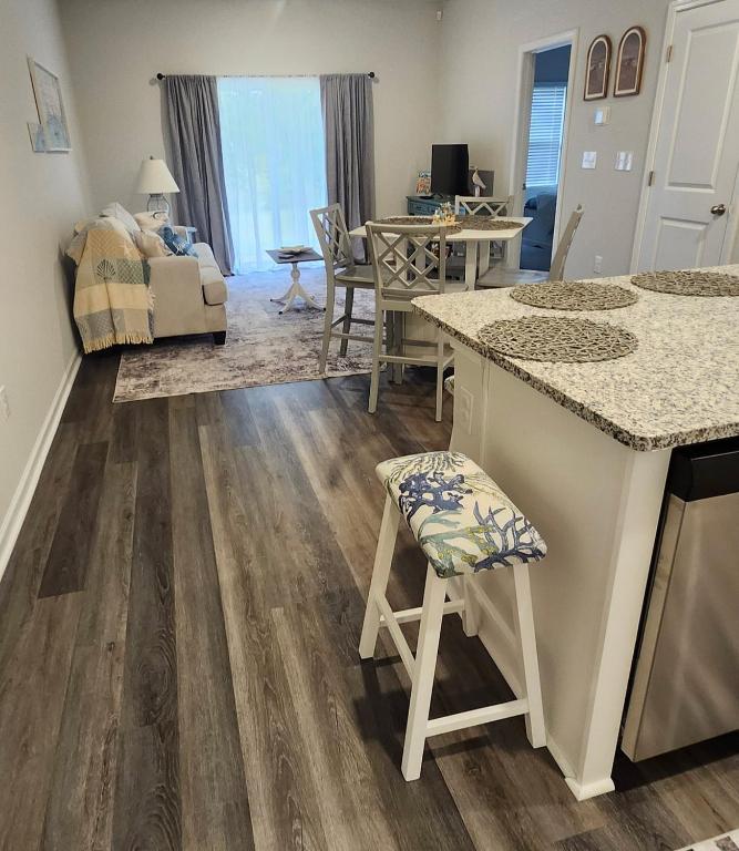 a kitchen and living room with a counter top at Sunset Beach townhome close to everything in Ocean Isle Beach