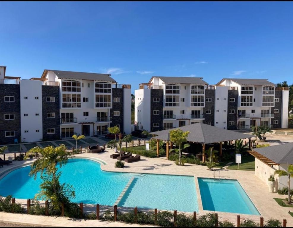 an aerial view of an apartment complex with a swimming pool at Samana condo by the beach in Las Terrenas