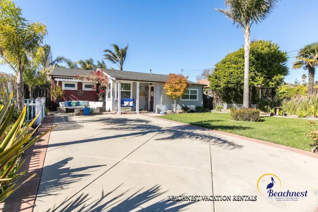 a house with palm trees and a driveway at Beach Lovers Retreat in Santa Cruz