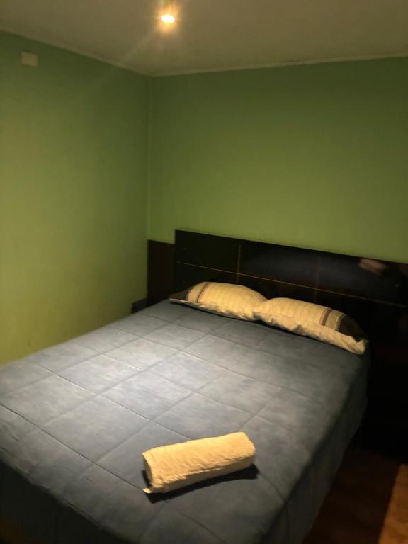a bedroom with a bed with a towel on it at Cabañas rio fuy Tinaja in Puyehue