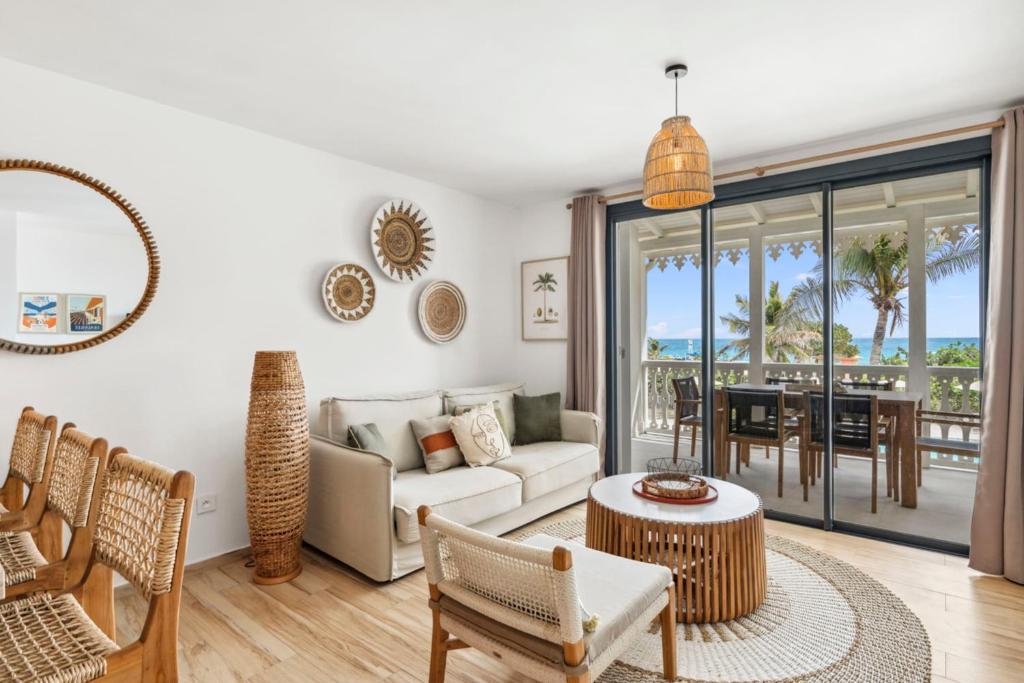 a living room with a couch and a table at Alamanda 114 Oceanview 2BR Steps from Orient Bay in Orient Bay