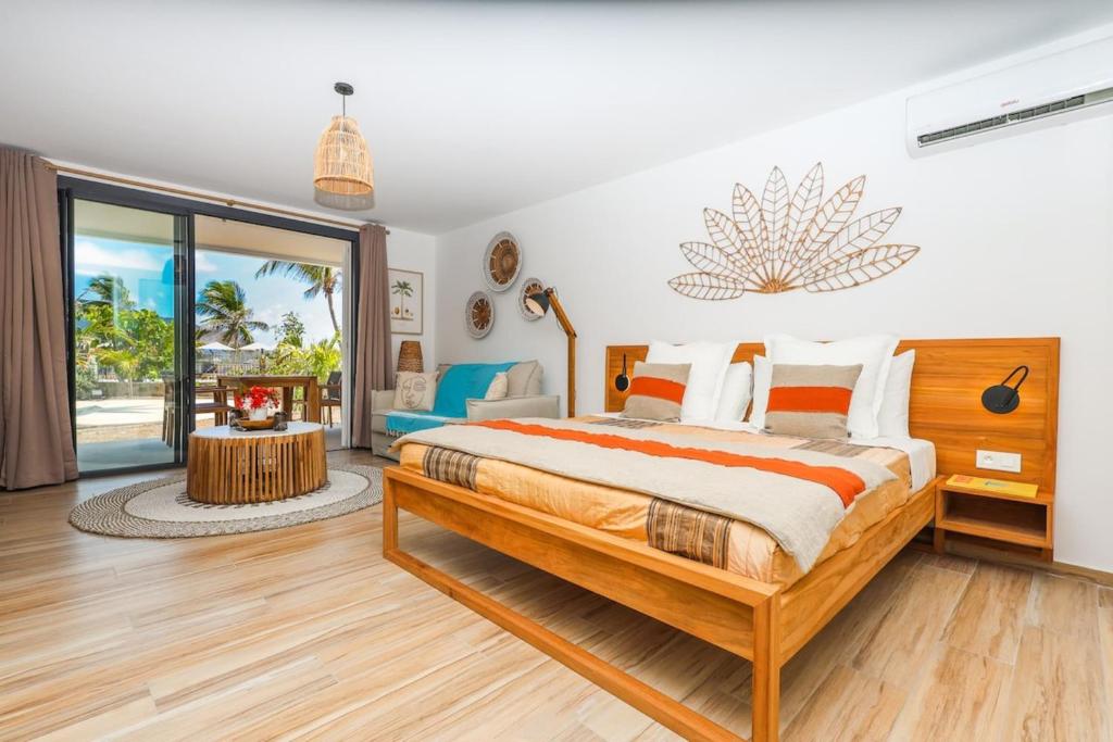 a bedroom with a large bed and a view of the ocean at Studio 6 Alamanda Resort Orient Bay in Orient Bay