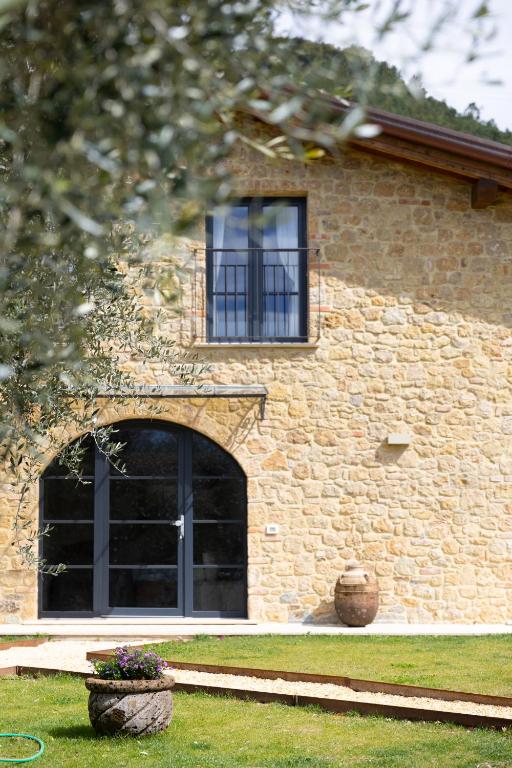 a brick building with a window and a door at Casa Gabri Boutique B&B Tuscan Villa retreat in Massa