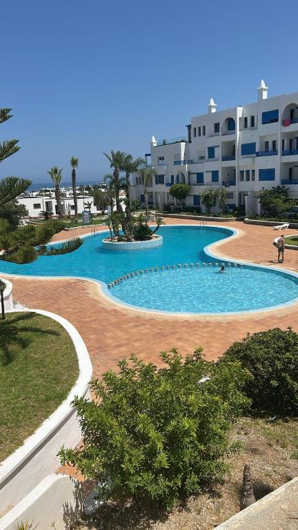 a large swimming pool in front of a building at kabila vista Z1 2 chambres in M'diq
