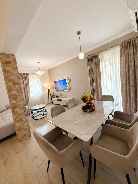 a living room with a dining room table and chairs at Apartman VUKAN in Budva