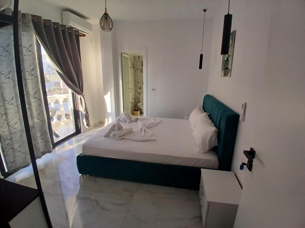 a small bed in a room with a window at Hotel Bar Pizzeria Verona in Ksamil