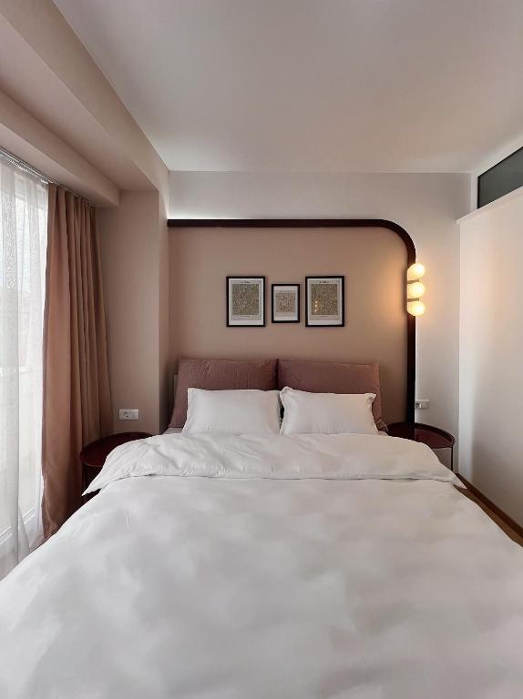 a large white bed in a room with a window at 2001 Central Stay in Peje