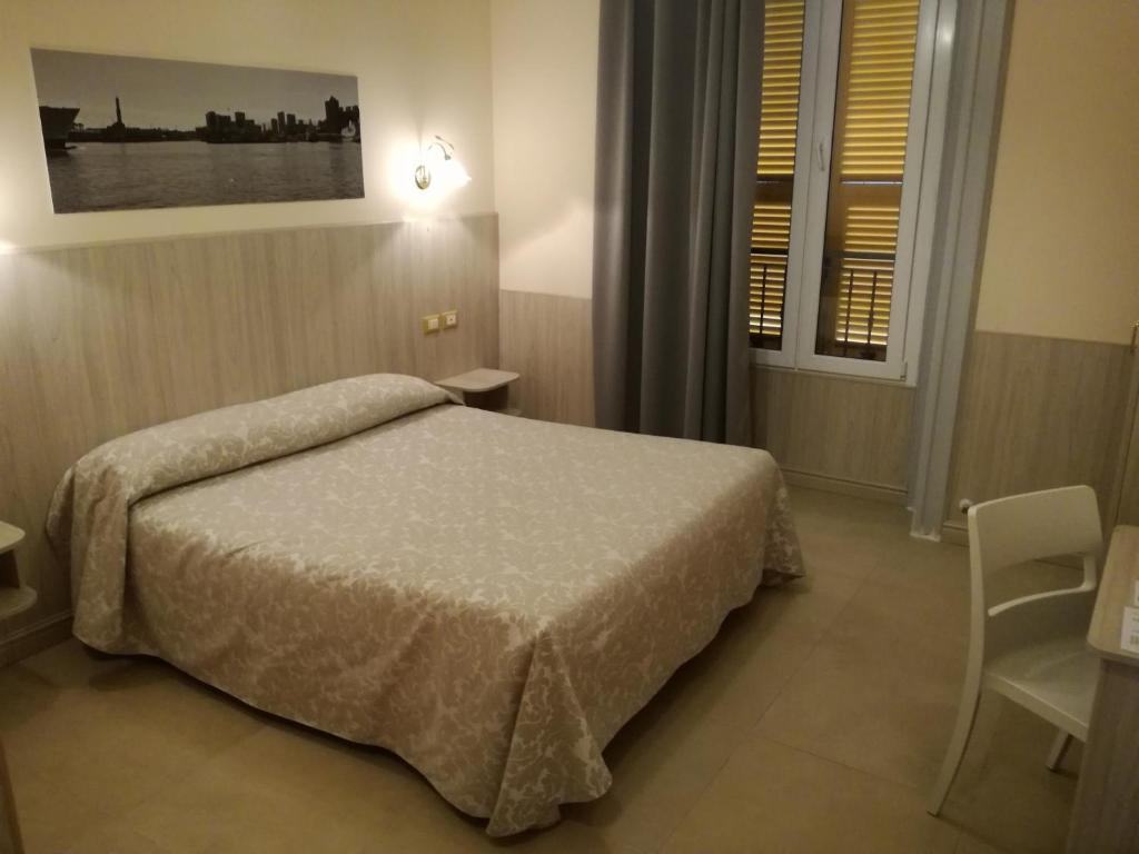 Łóżko lub łóżka w pokoju w obiekcie Hotel Cantore