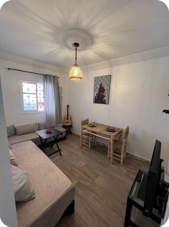 a living room with a couch and a table at White House TAMRAGHT in Agadir