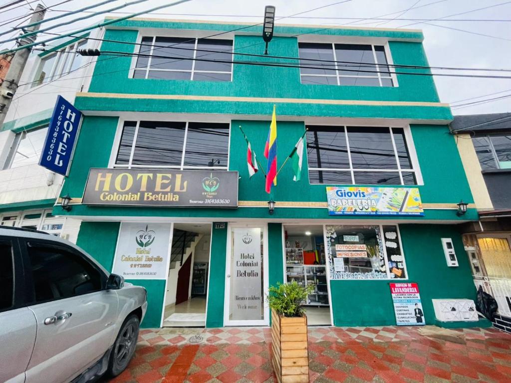 a hotel building with a car parked in front of it at Hotel Colonial Betulia D in Tunja