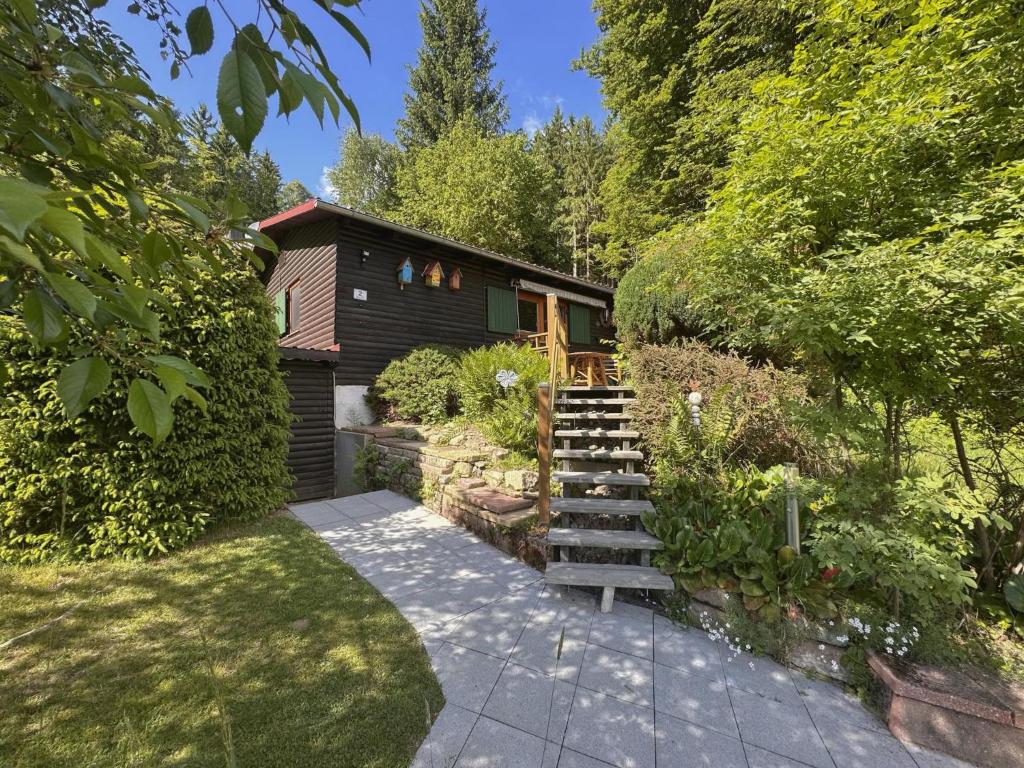 a house with a wooden staircase in a garden at Haus Anna in Stadlern