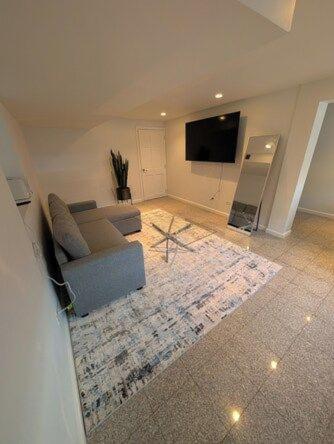 a living room with a couch and a flat screen tv at Comfortable living, within reach! in Oak Park