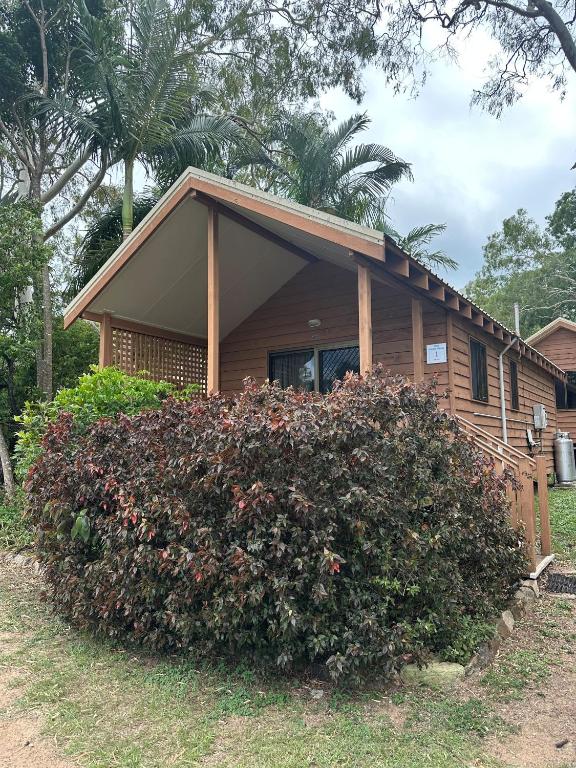 a house with a large bush in front of it at 1770 Holiday Village in Seventeen Seventy