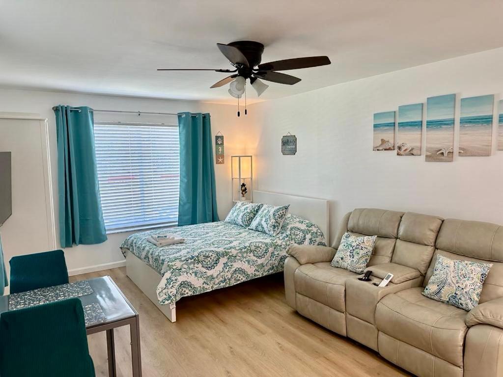 a living room with a couch and a bed at Seashell 5 in Boynton Beach