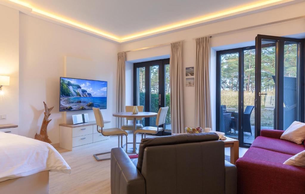 a bedroom with a bed and a living room with a table at Baltic in Binz