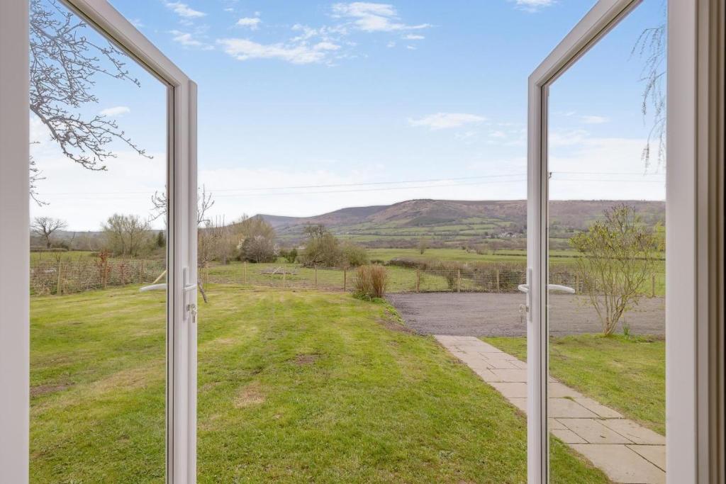 an open window with a view of a river and mountains at 2 Bed in Llangasty oc-d39006 in Llangorse