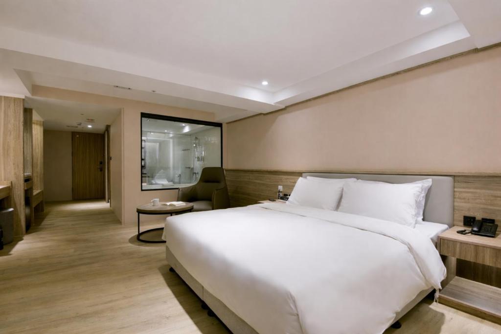 a large white bed in a hotel room at Spring Rhapsody Hotel in Taichung