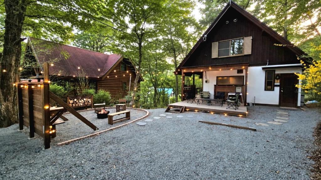 a house with a playground in front of it at Cabin Dilusso in Hokuto